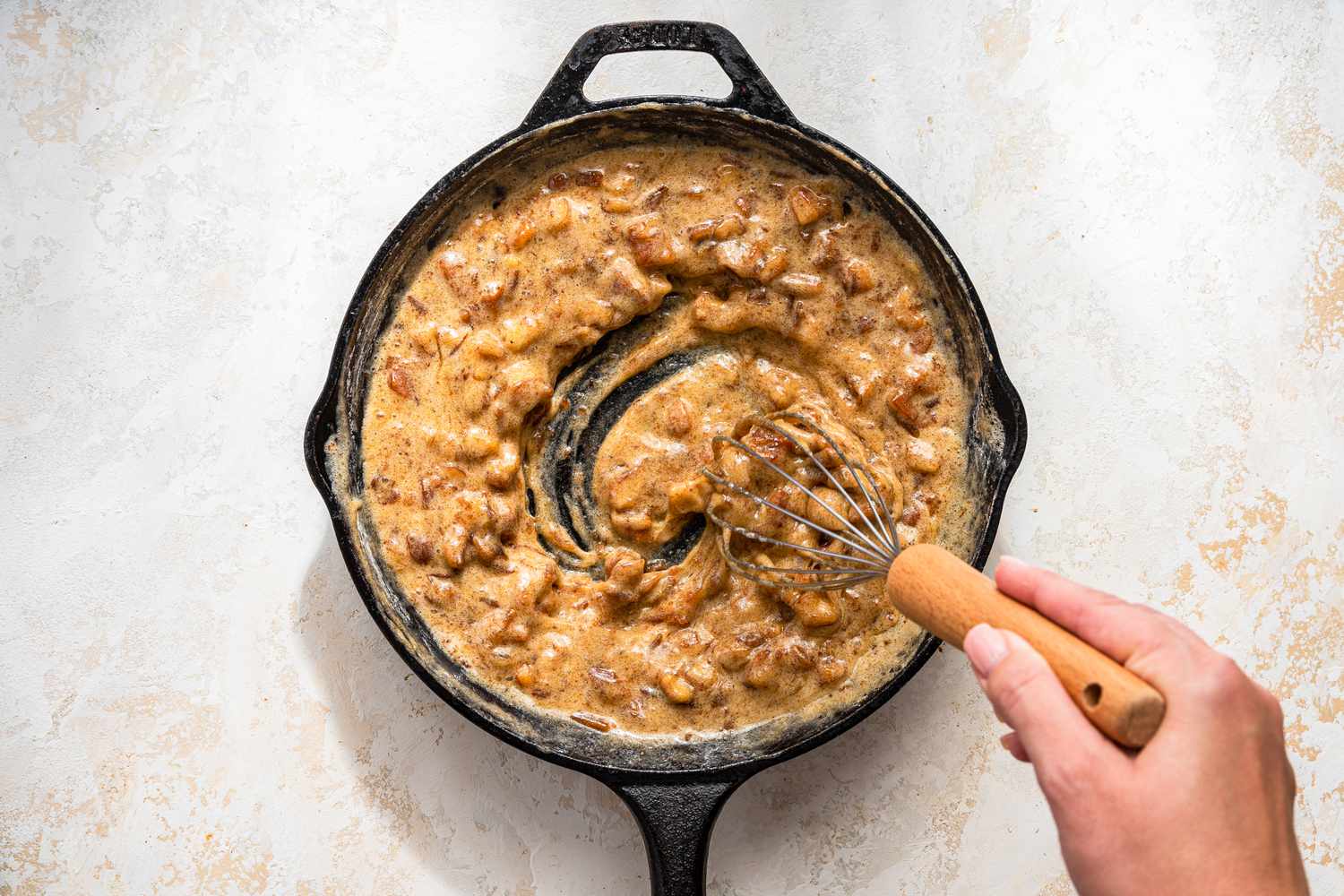 Dates and egg-sugar mixture whisked together in a cast iron skillet until frothy