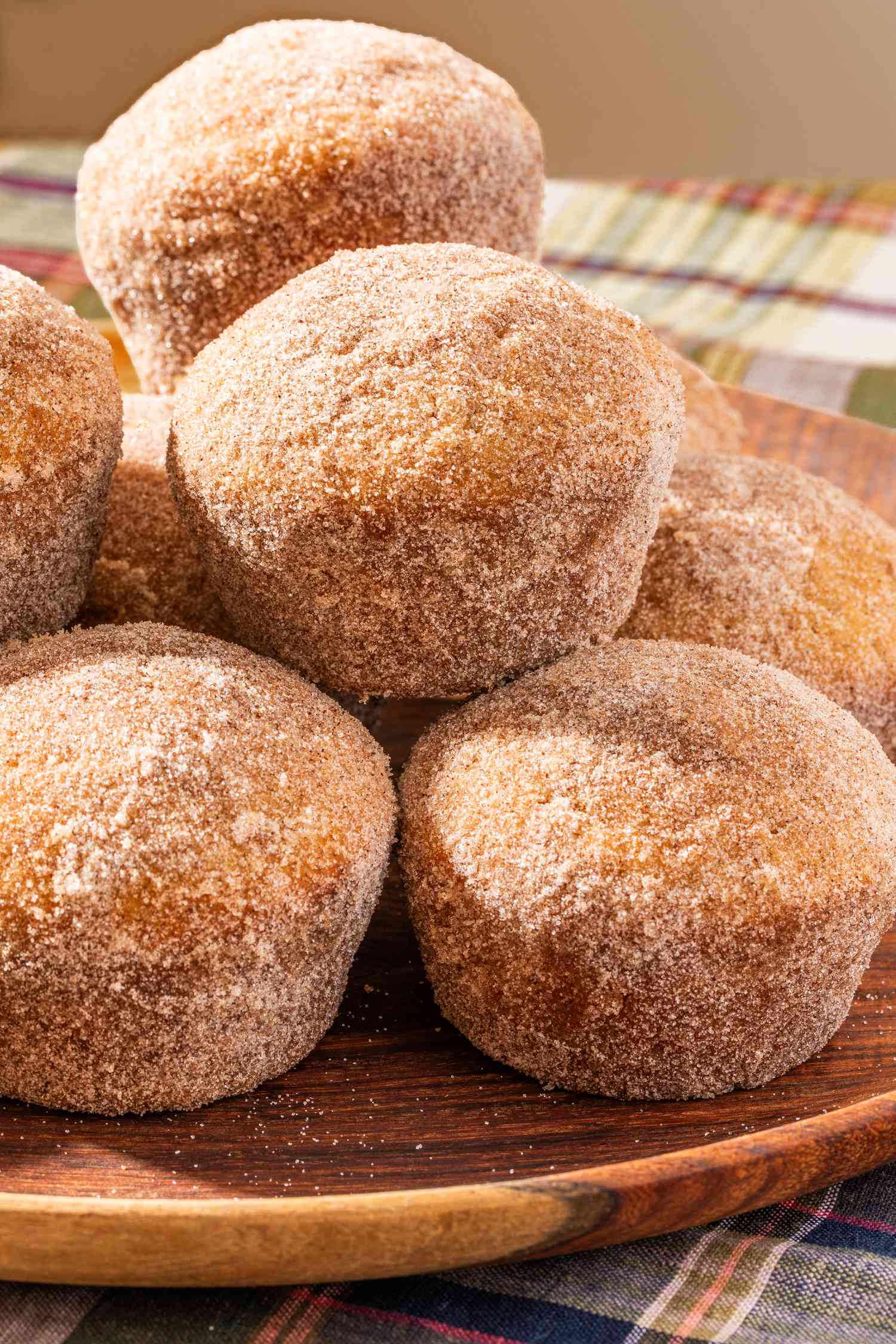 apple cider donut muffins puled up on a wooden plate