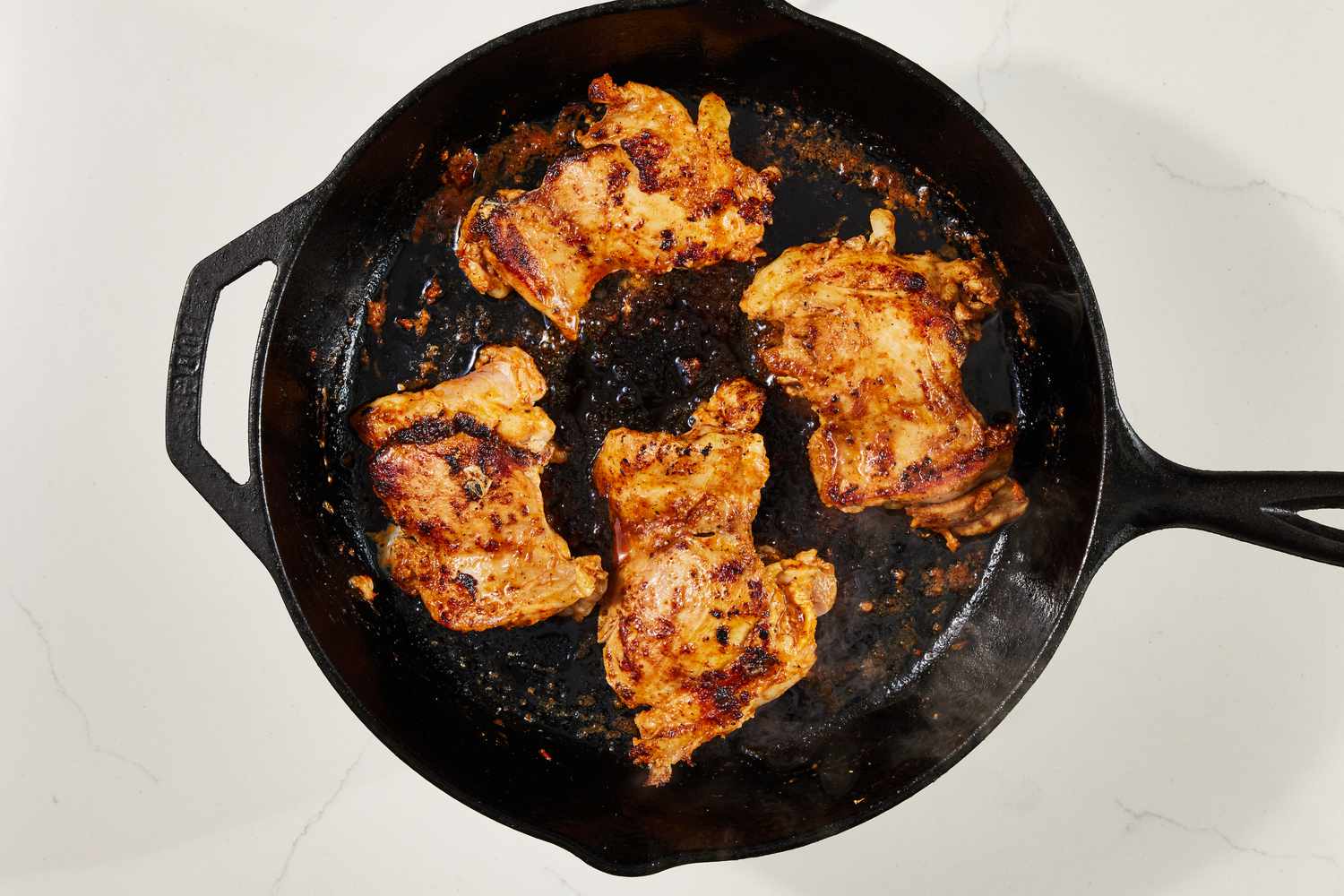Copycat Chipotle chicken flipped and continued to cook on a cast iron skillet