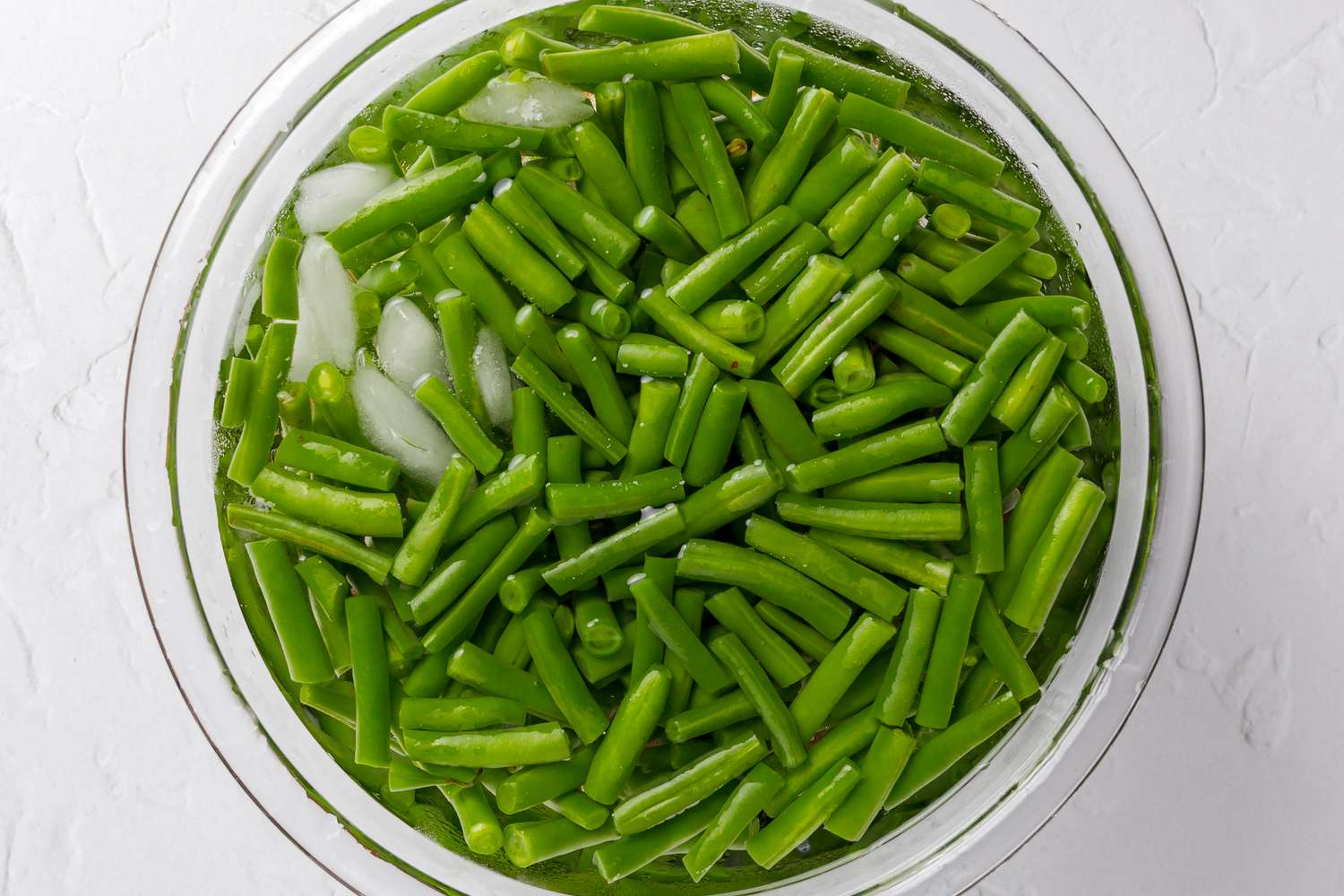 Blanched Green Beans in Bowl of Ice Water for Green Bean Casserole in a Slow Cooker