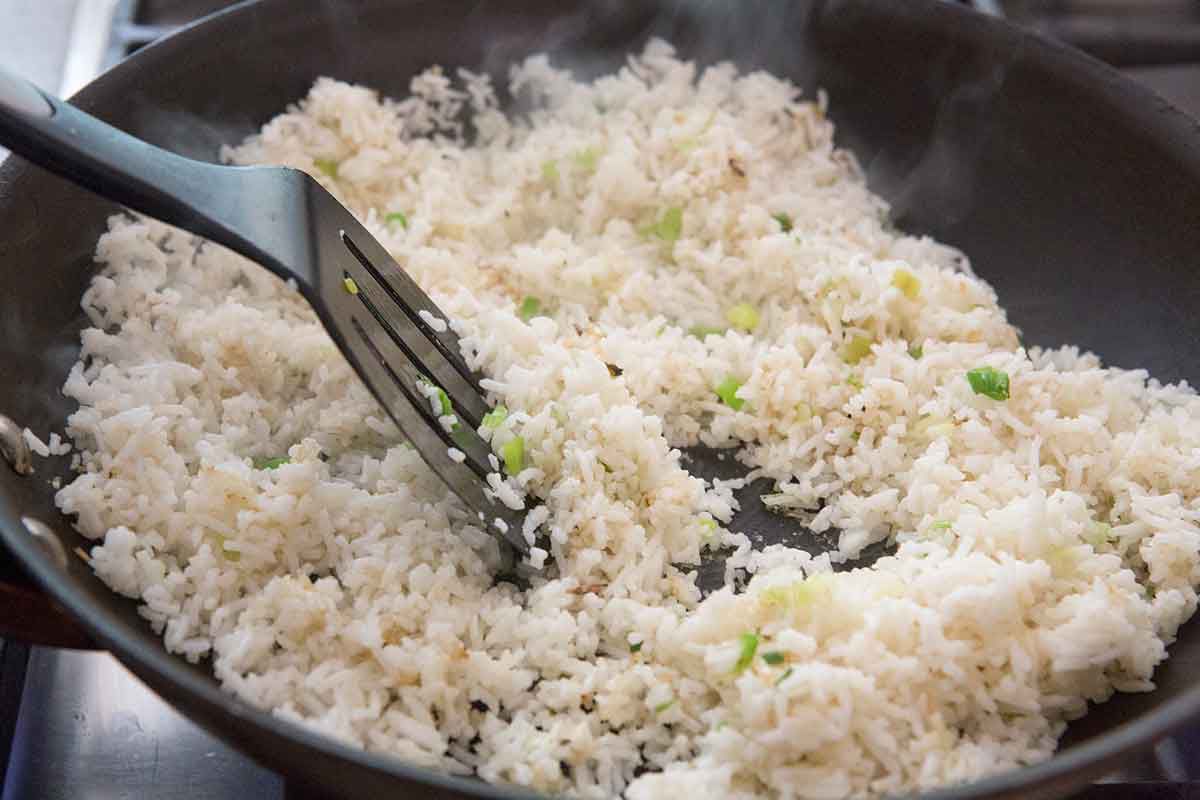 Rice added to cooking green onions 