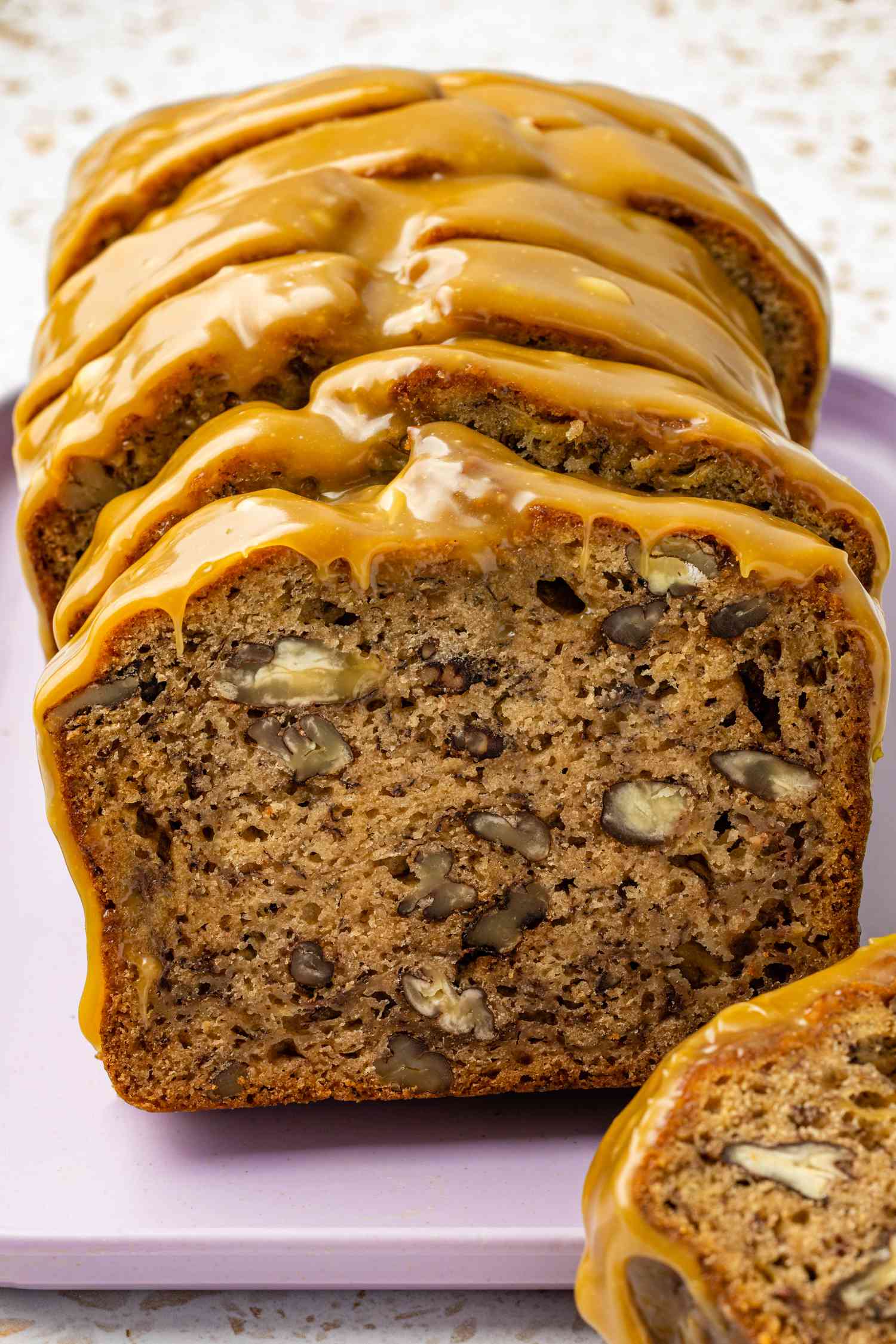 Banana Pecan Bread with Caramelized White Chocolate Sorghum Glaze Cut Into Slices With the Cross Section Showcased