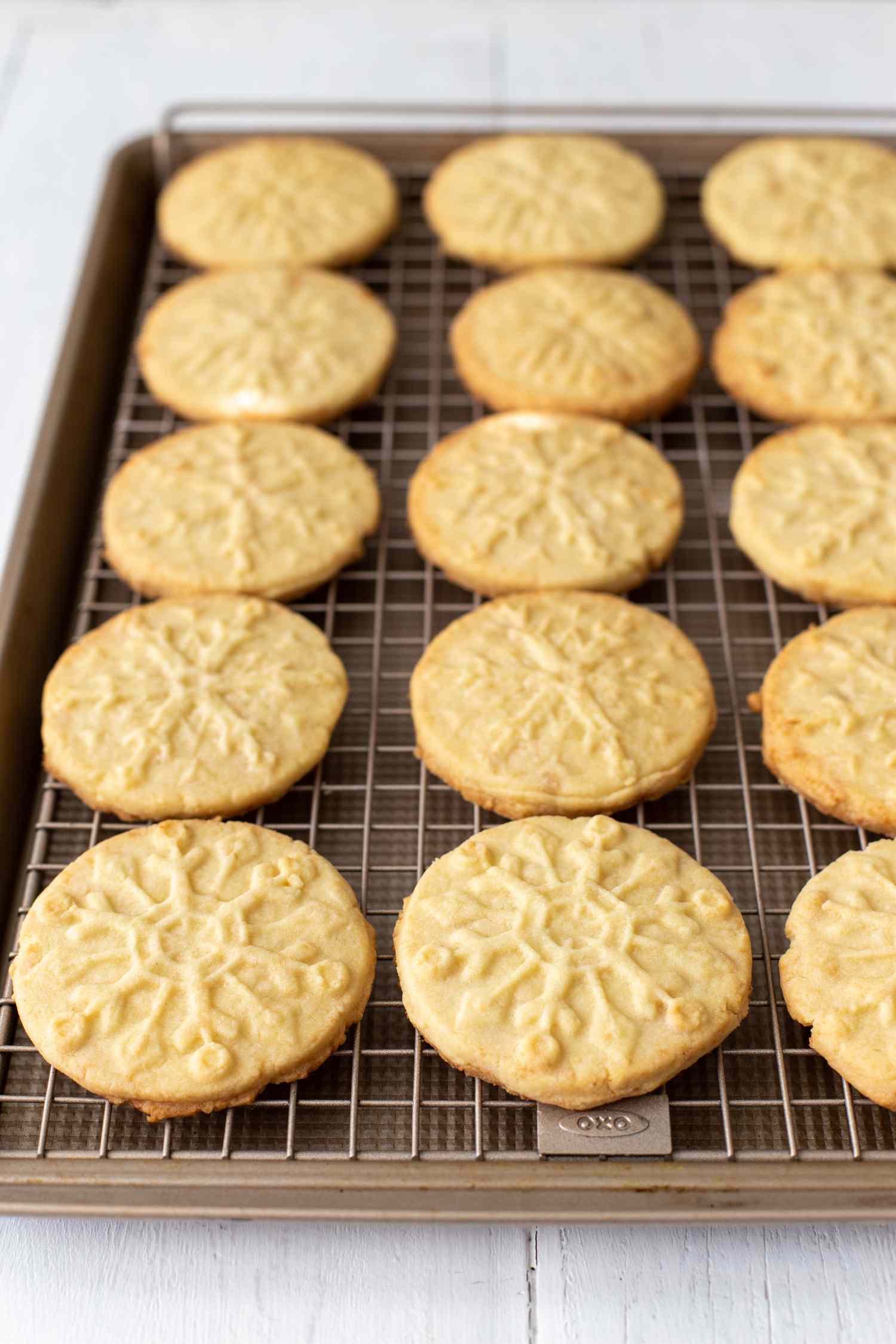Almond-flavored butter cookies on a baking sheet.