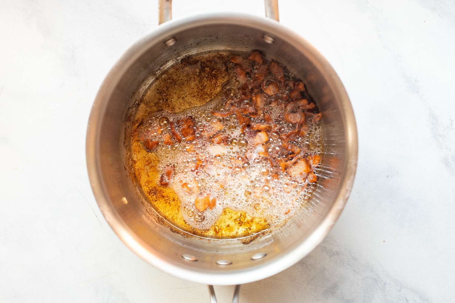 Cook bacon in pot.