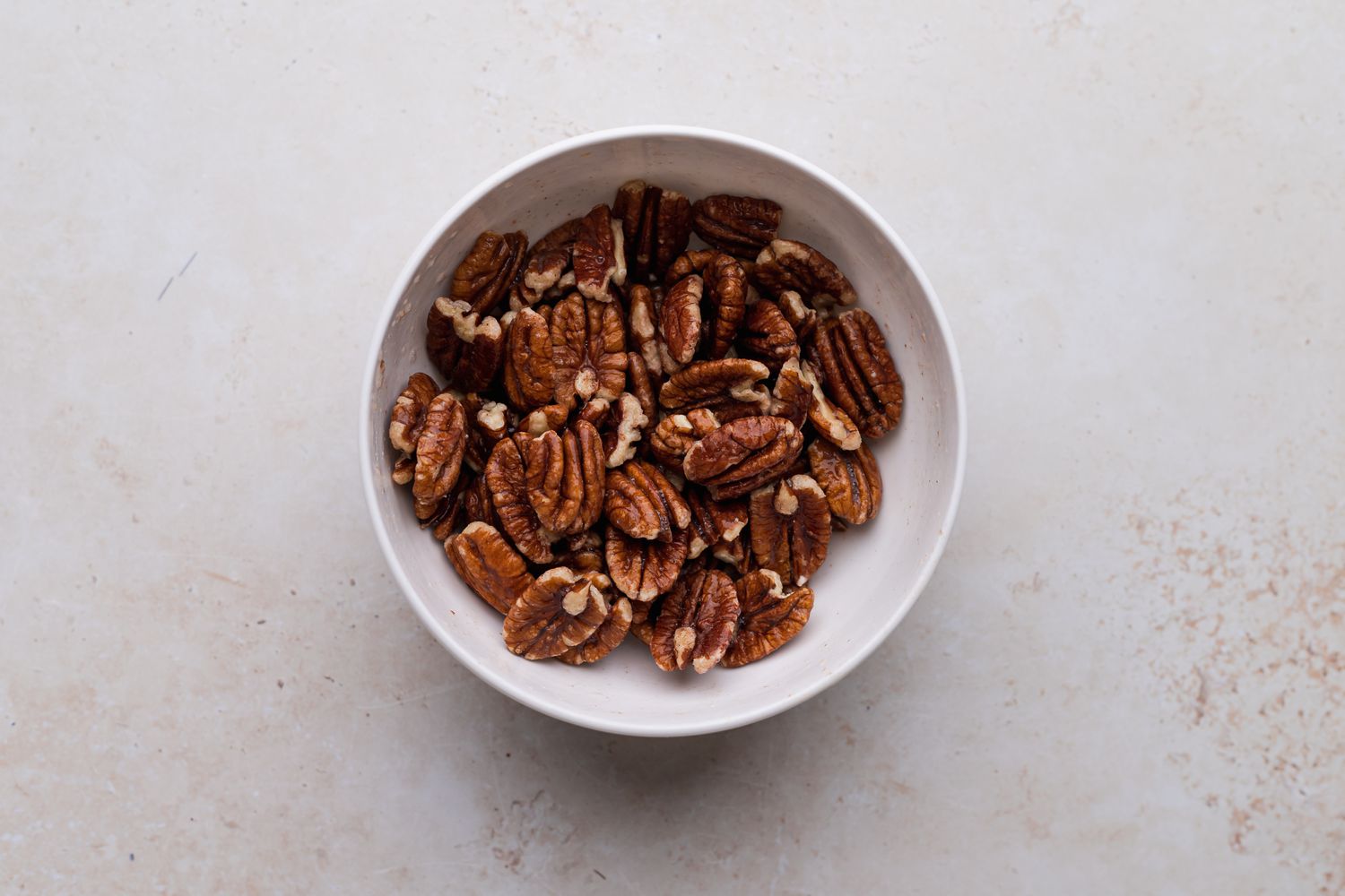 Pecans in a bowl to show how to make candied pecans