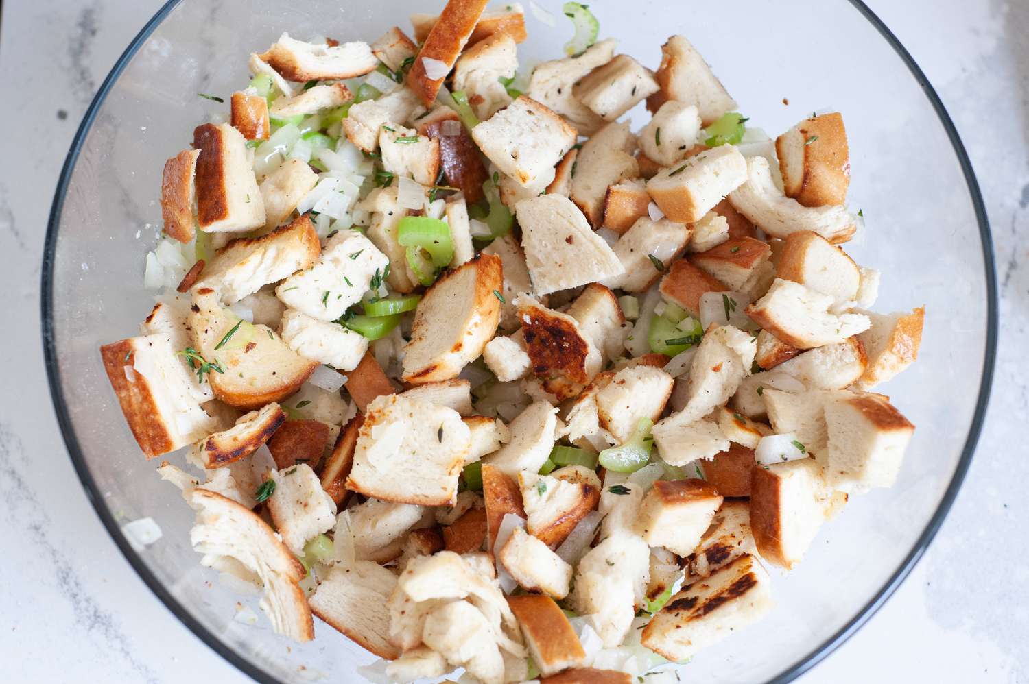 Toss bread and vegetables together.