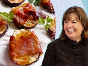 Ina Garten smiling next to a dish of fig and prosciutto appetizers on a plate with cream and garnishes