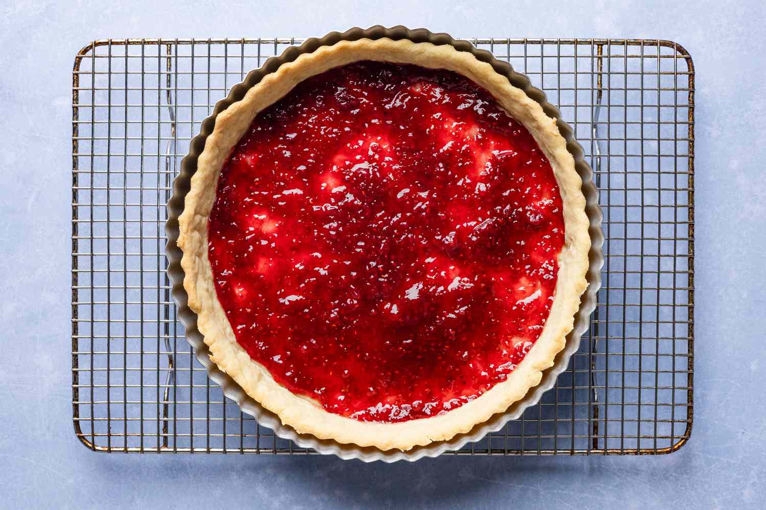 jam added to shortcrust tart shell (still in pan and on cooling rack) for cornflake tart recipe