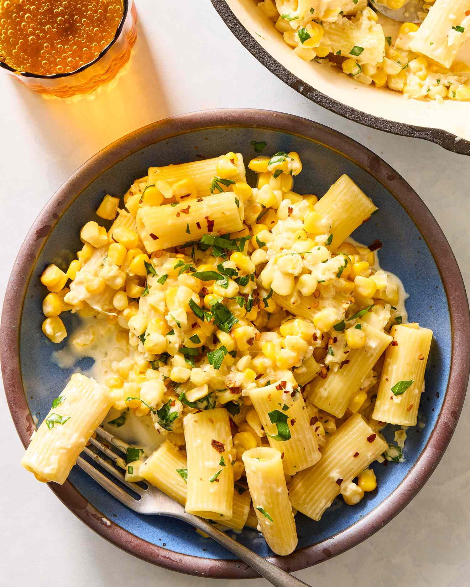 Plate of pasta with fresh corn and herbs