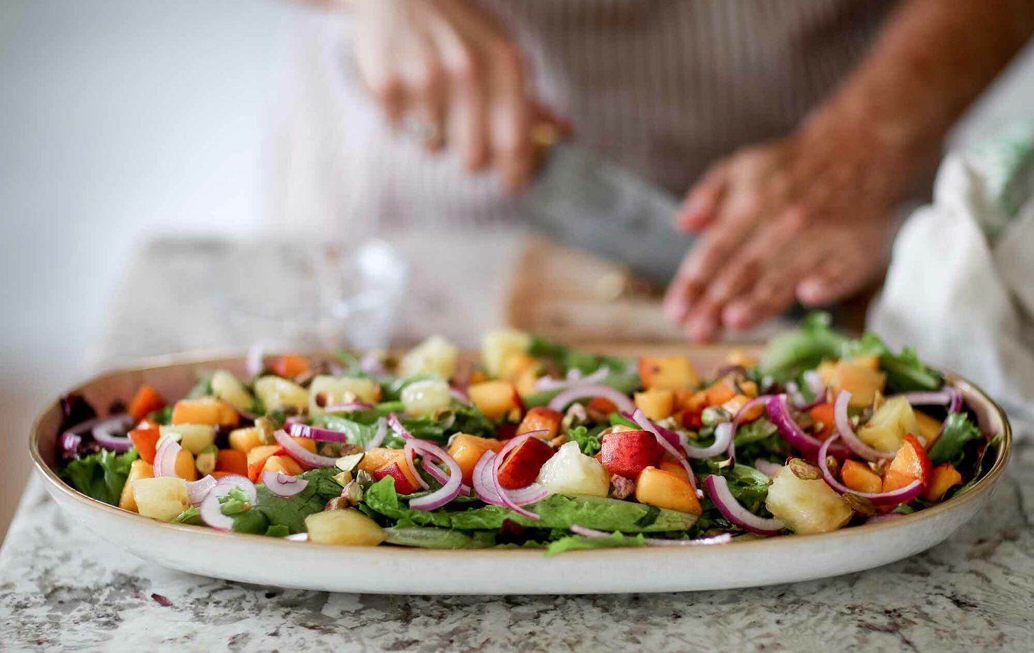Side salad recipe with peaches, goat cheese, and pistachios