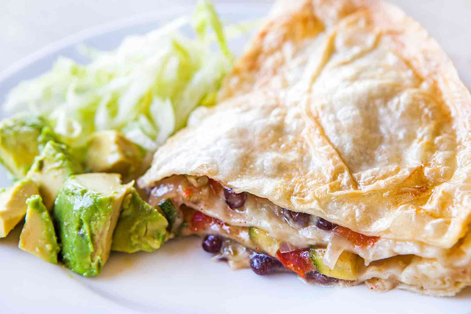 A slice of quesadilla pie on a plate