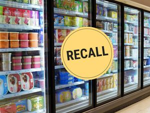 Frozen food section of a grocery store with a recall sign overlayed