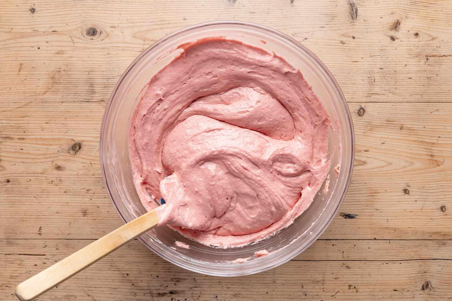 strawberry cake batter in a bowl with a spatula for strawberry cake recipe