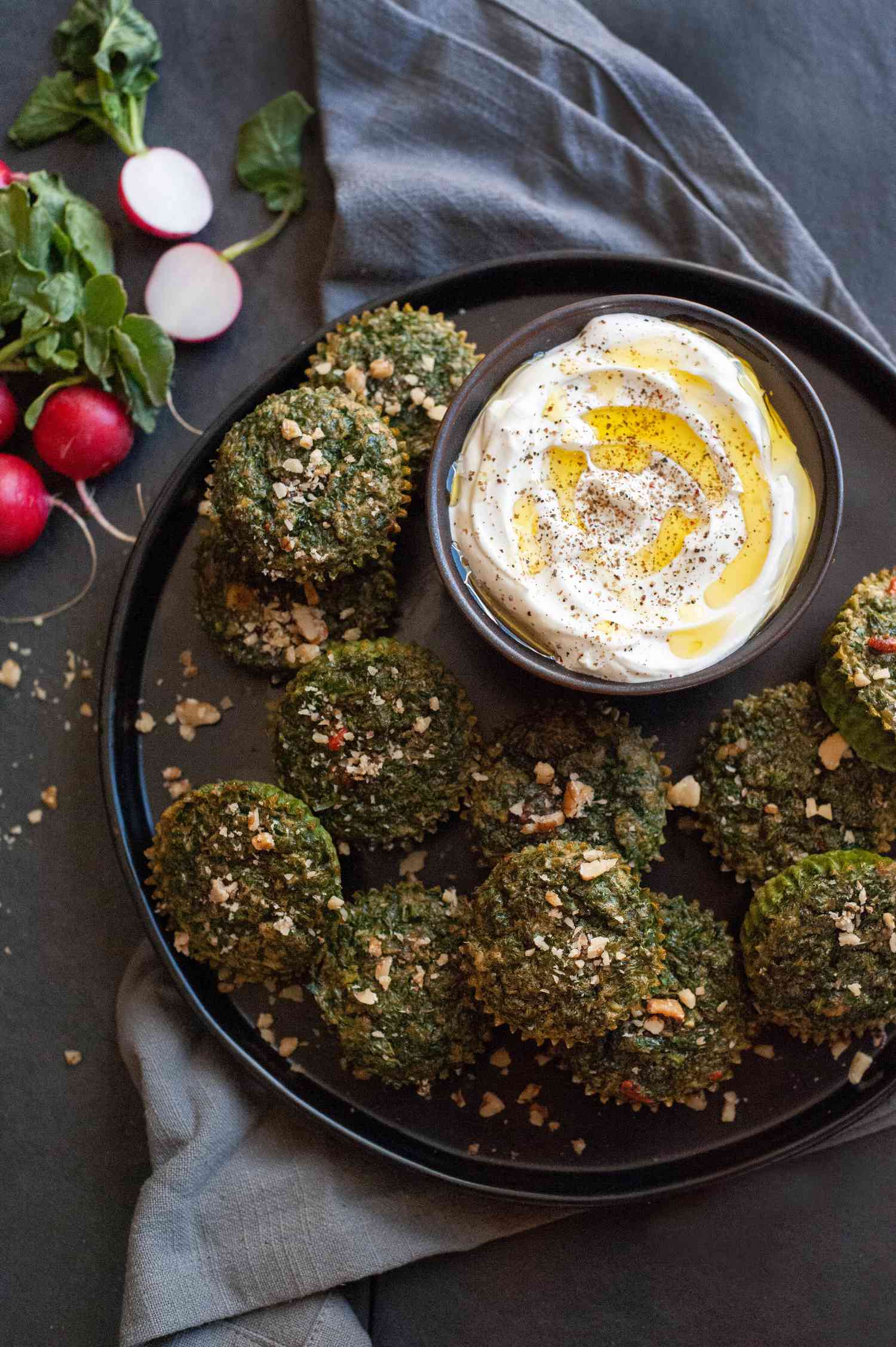 Kuku Sabzi on platter with yogurt dip.