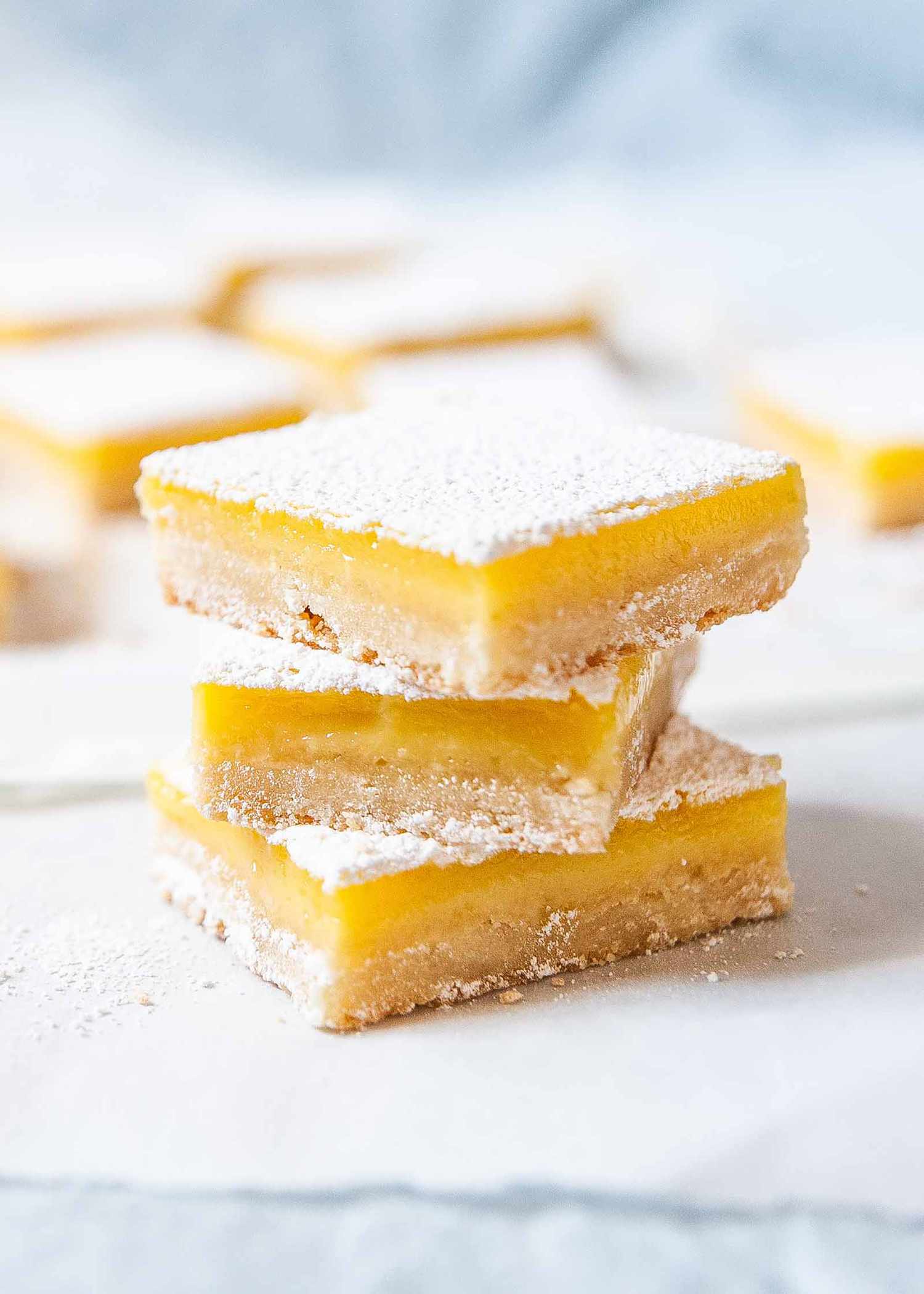 Best Lemon Bars - lemon bars stacked on top of each other