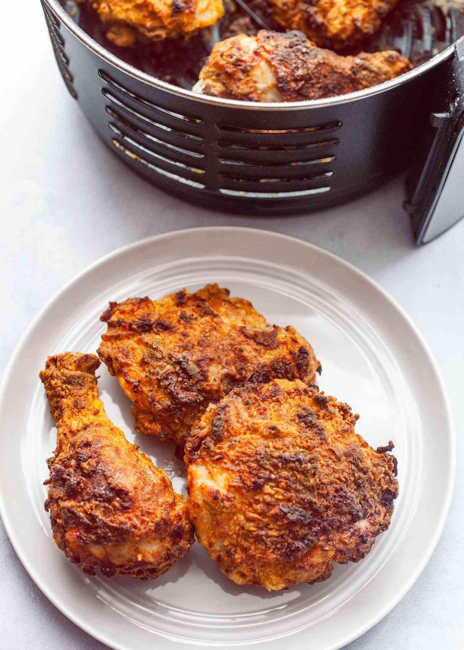 An air fryer with pieces of breaded air fried chicken in the fryer basket