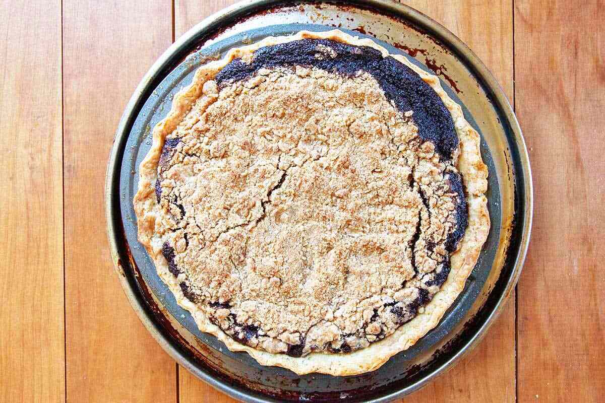 Best shoofly pie with a crumb topping and the filling visible along the edges.