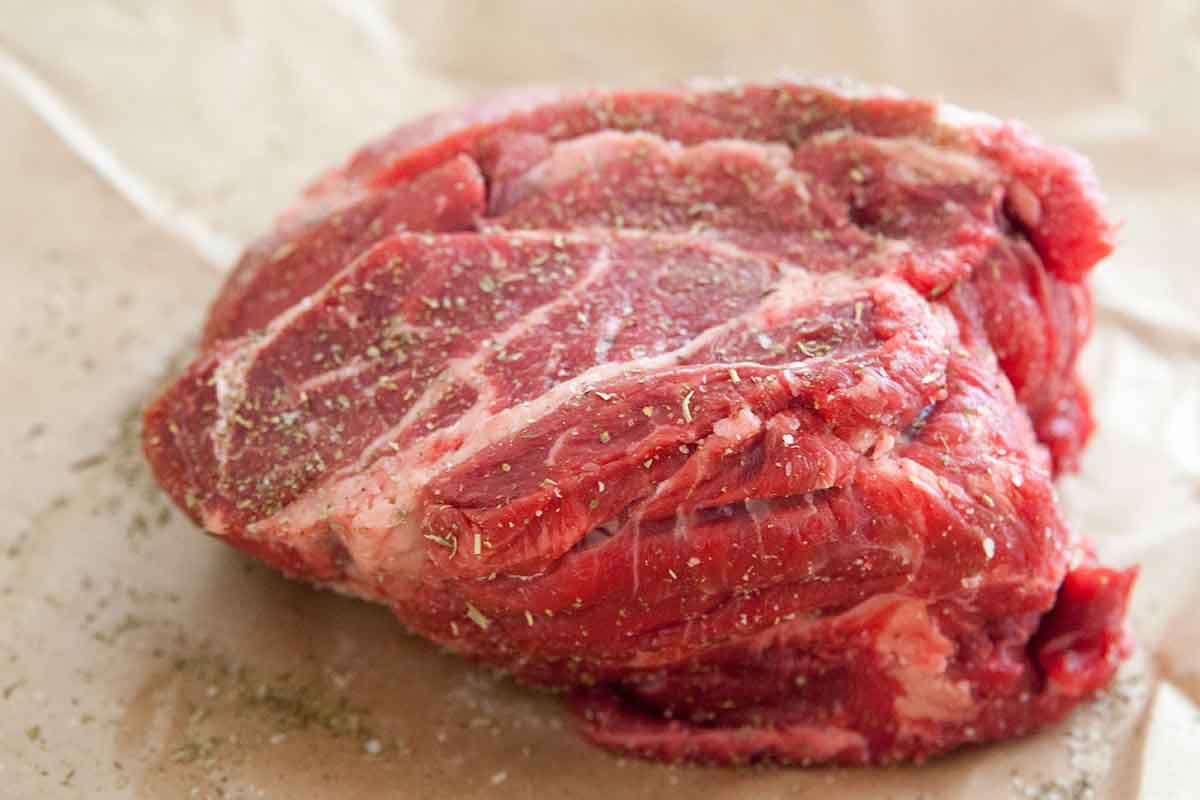 Chuck Roast meat for a pot roast on parchment paper