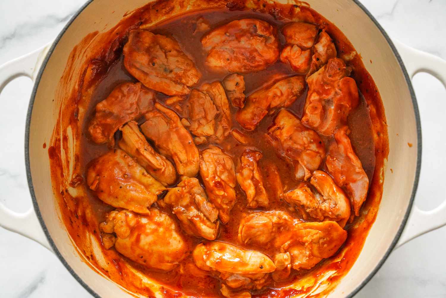 Dutch Oven With Cooked Chicken Thighs for Pulled Chicken Recipe