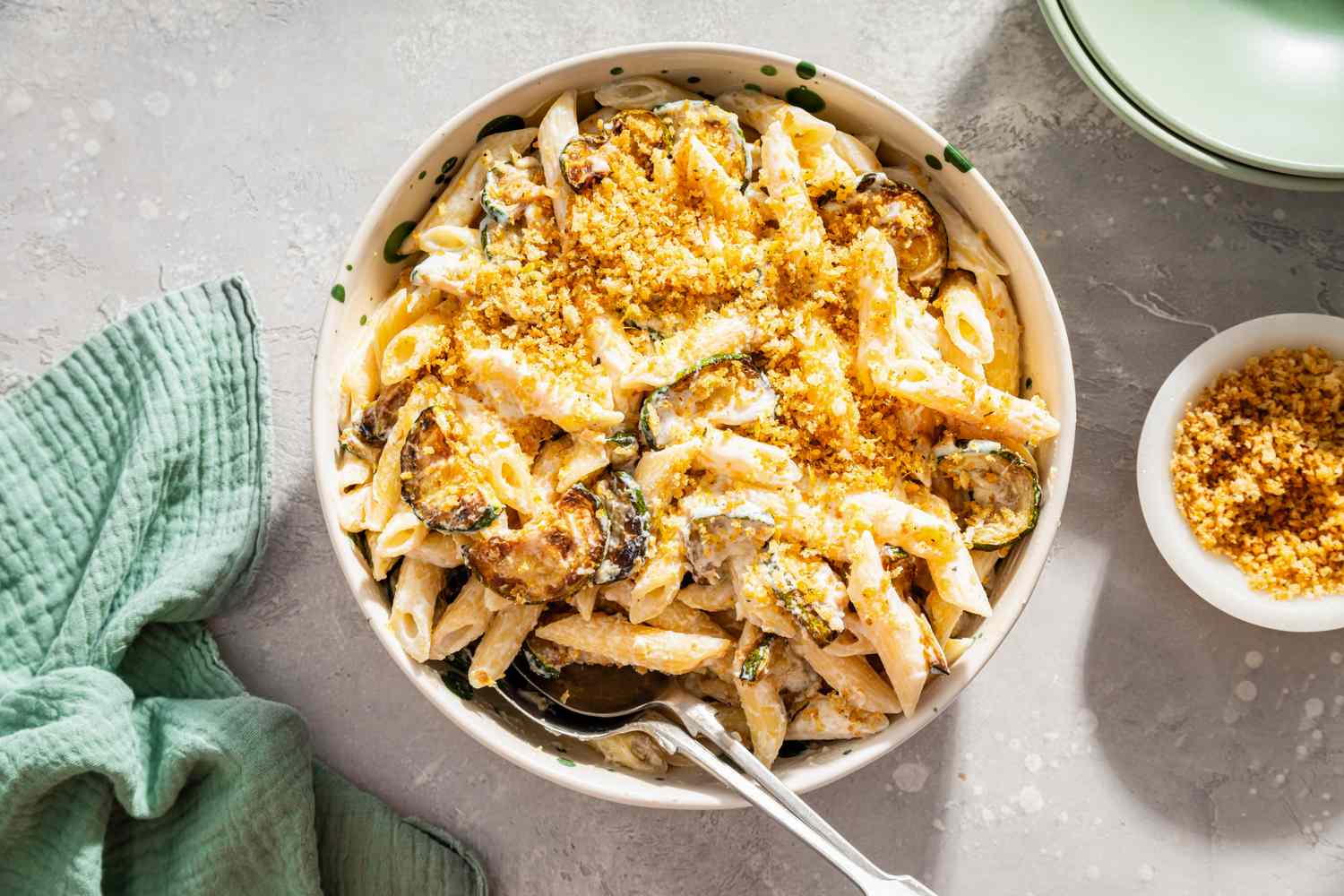 Bowl of pasta with zucchini ricotta and breadcrumbs on a table