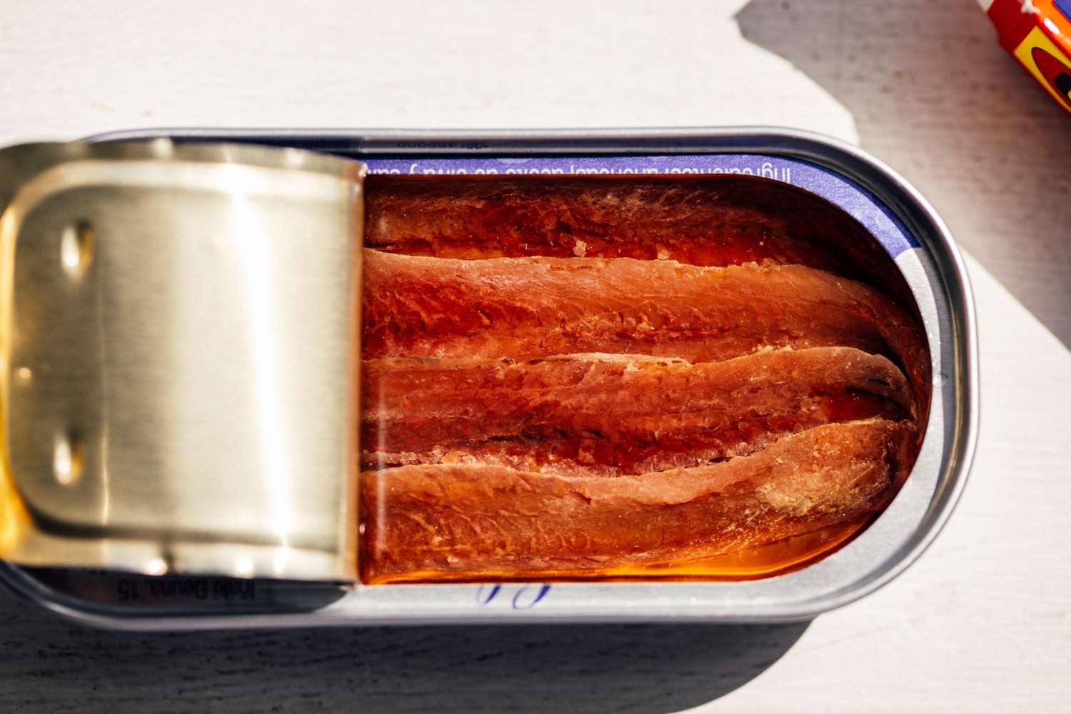 Opened can of anchovy fillets in oil