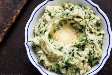 Colcannon (Irish mashed ptoatoes) in a bowl topped with butter