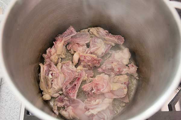Chicken pieces in a stock pot