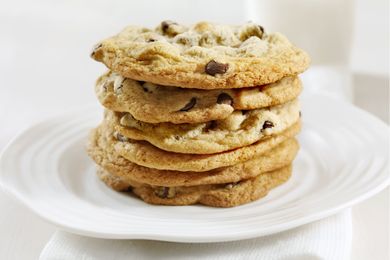 A stack of chocolate chip cookies on a white plate