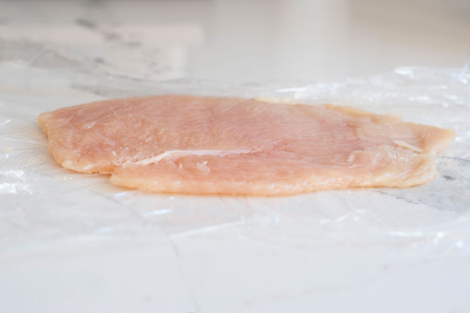 how to make chicken schnitzel: pound the chicken thin