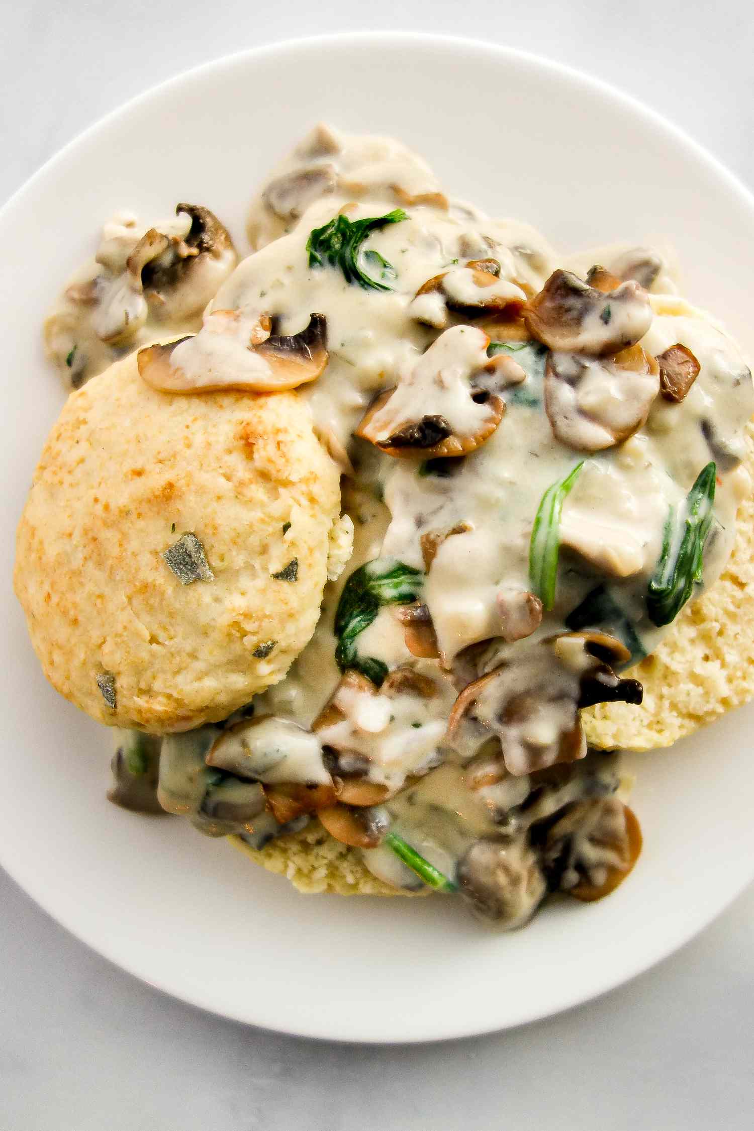 Vegetarian biscuits and gravy on a white plate.