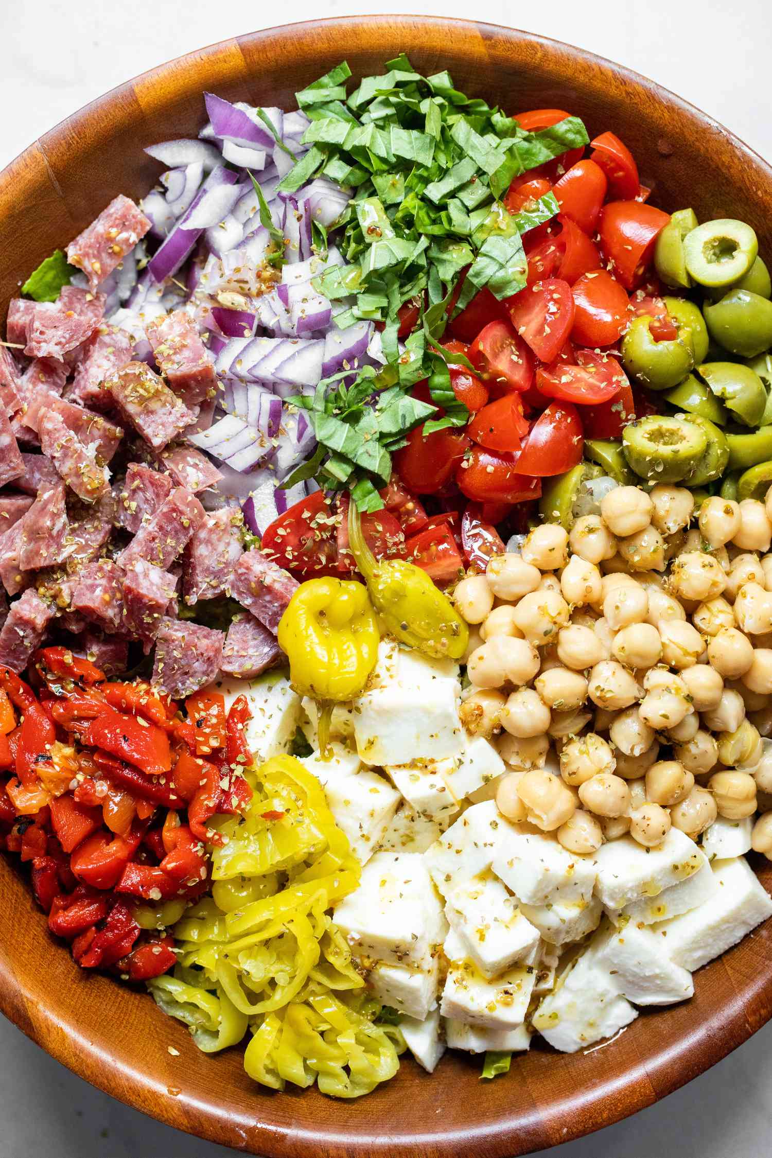 Large Bowl of Cheese, Peppers, Salami, Olives, Chickpeas, Onions, and Lettuce for Italian Chopped Salad 