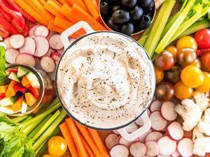 ranch dip in a mini dutch oven on a tray with vegetables