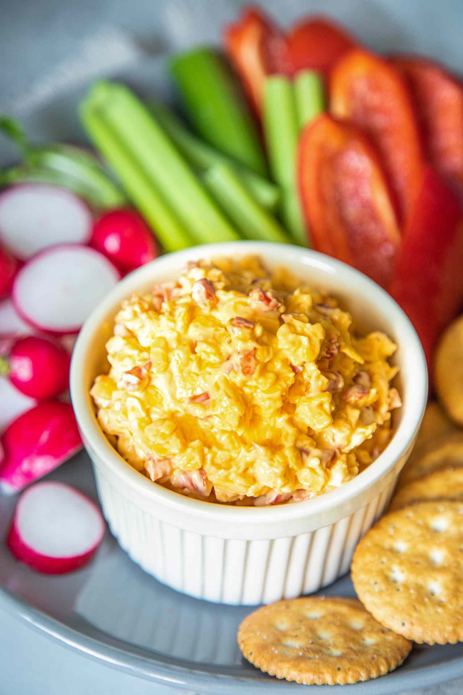 Pimento Cheese in a Bowl on Platter with Sliced Vegetables and Crackers