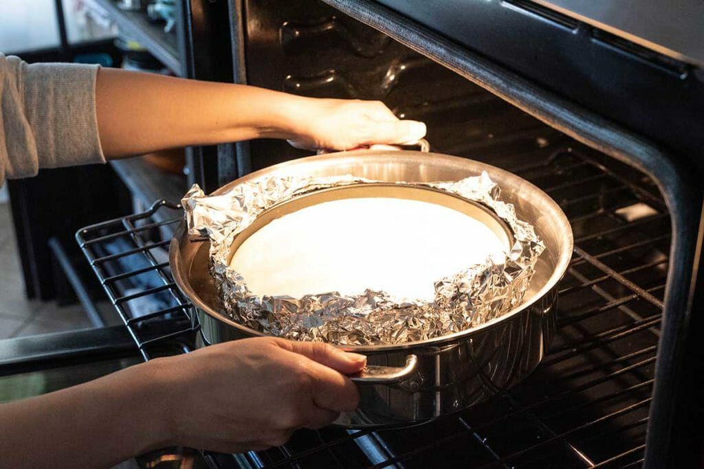 Easy Banoffee Cheesecake Recipe - putting pie in oven