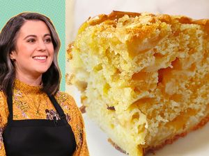 A smiling chef in a patterned top with an apron next to a slice of apple cake