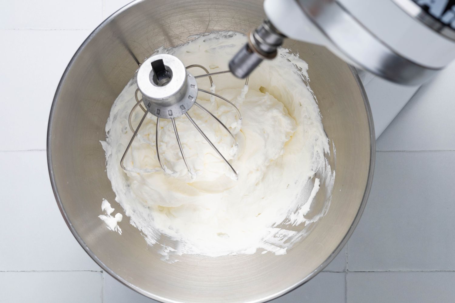 Whipped cream in a mixer bowl (still on the stand mixer) for Cookie crumb, butter, and sugar blended together in a food processor for no-bake pumpkin cheesecake recipe
