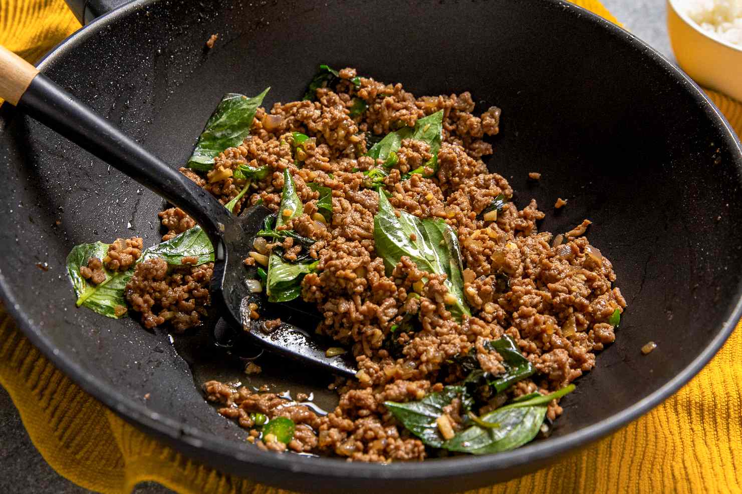 Beef Krapow in a wok with a spatula