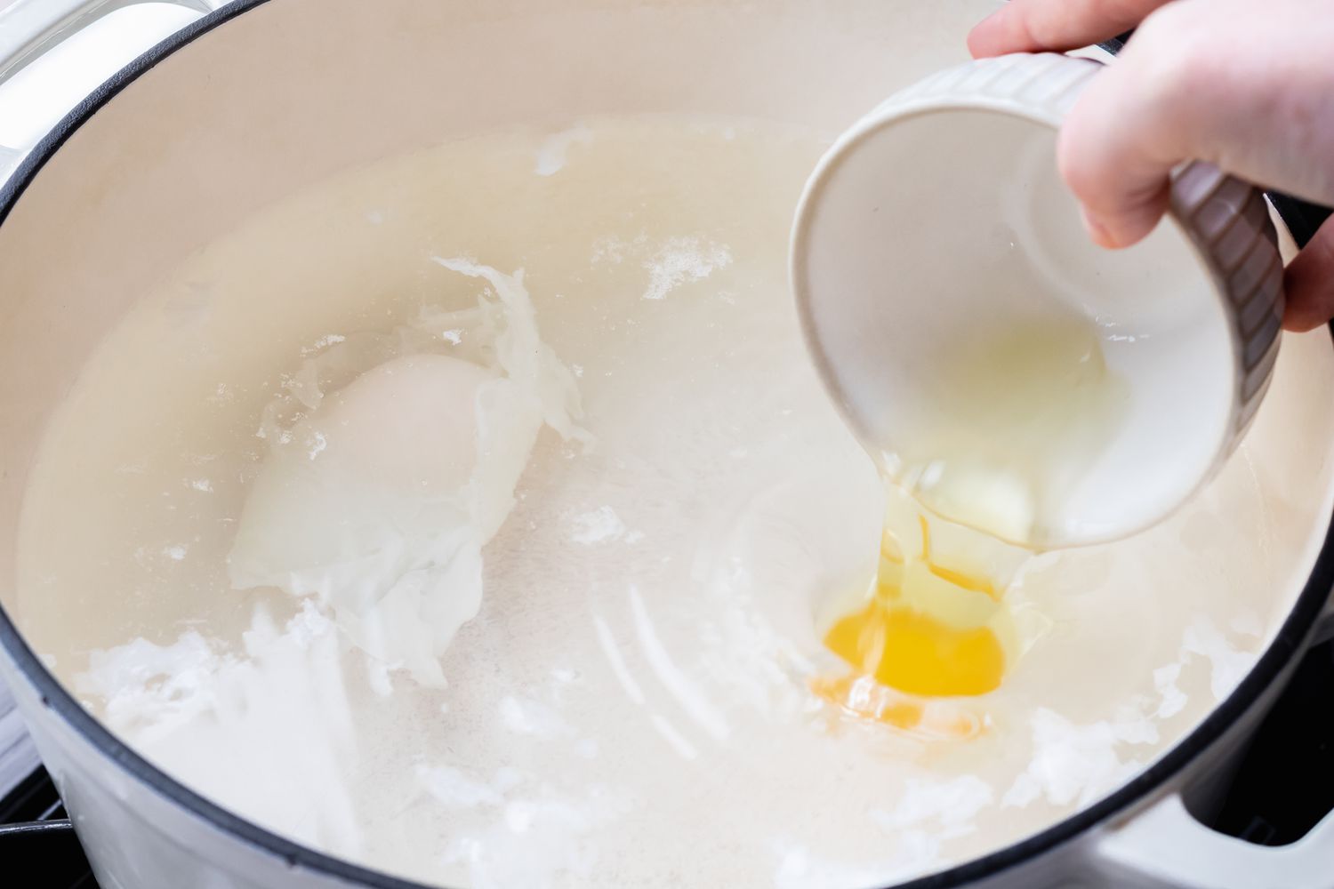 Poaching eggs in a pot of water