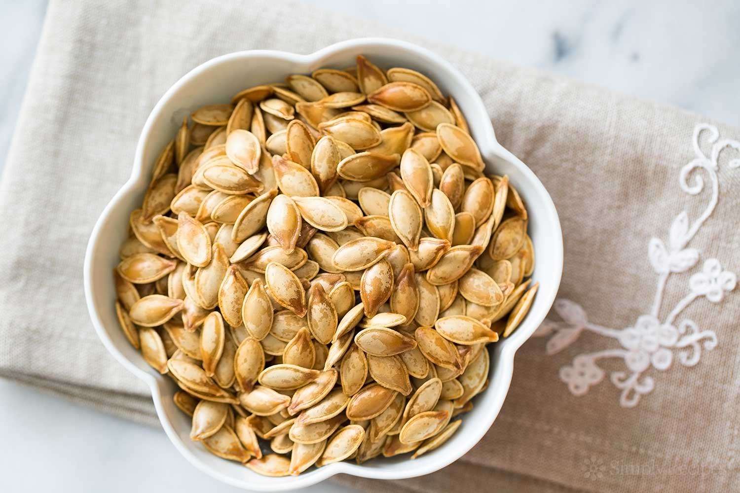Overhead of roasted pumpkin seeds in a bowl