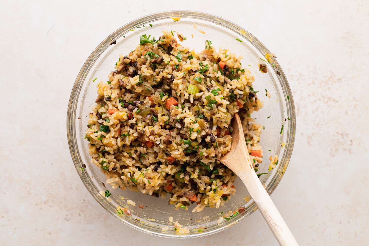 Mixing filling for stuffed squash in a glass bowl.