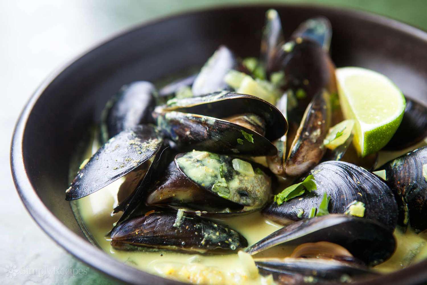 mussels in coconut curry sauce in a bowl