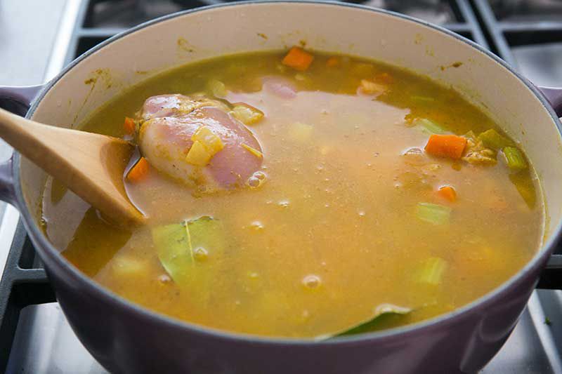 Soup pot with vegetables and chicken in a Dutch oven