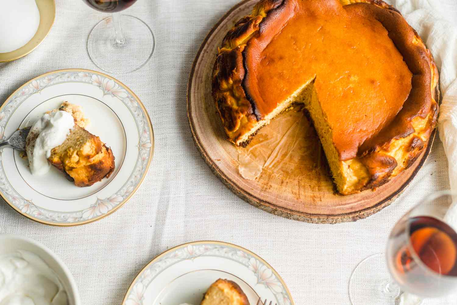 Basque-style cheesecake with slices cut out of it.