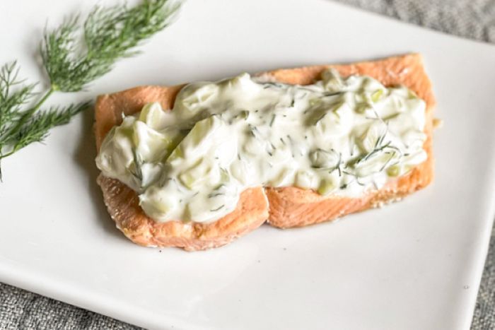 poached salmon covered in tzatziki