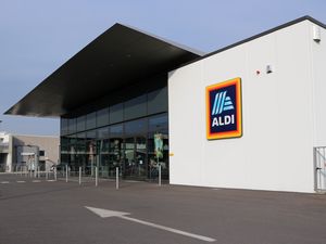 ALDI retail store exterior with a glass storefront and logo sign