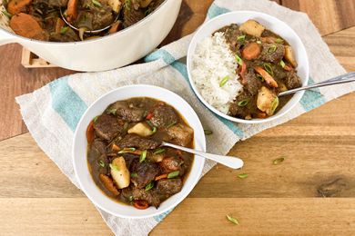 Two bowls of Jamaican Beef Stew served with rice.