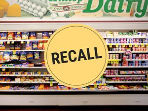 Supermarket dairy section with a large Recall sign overlay