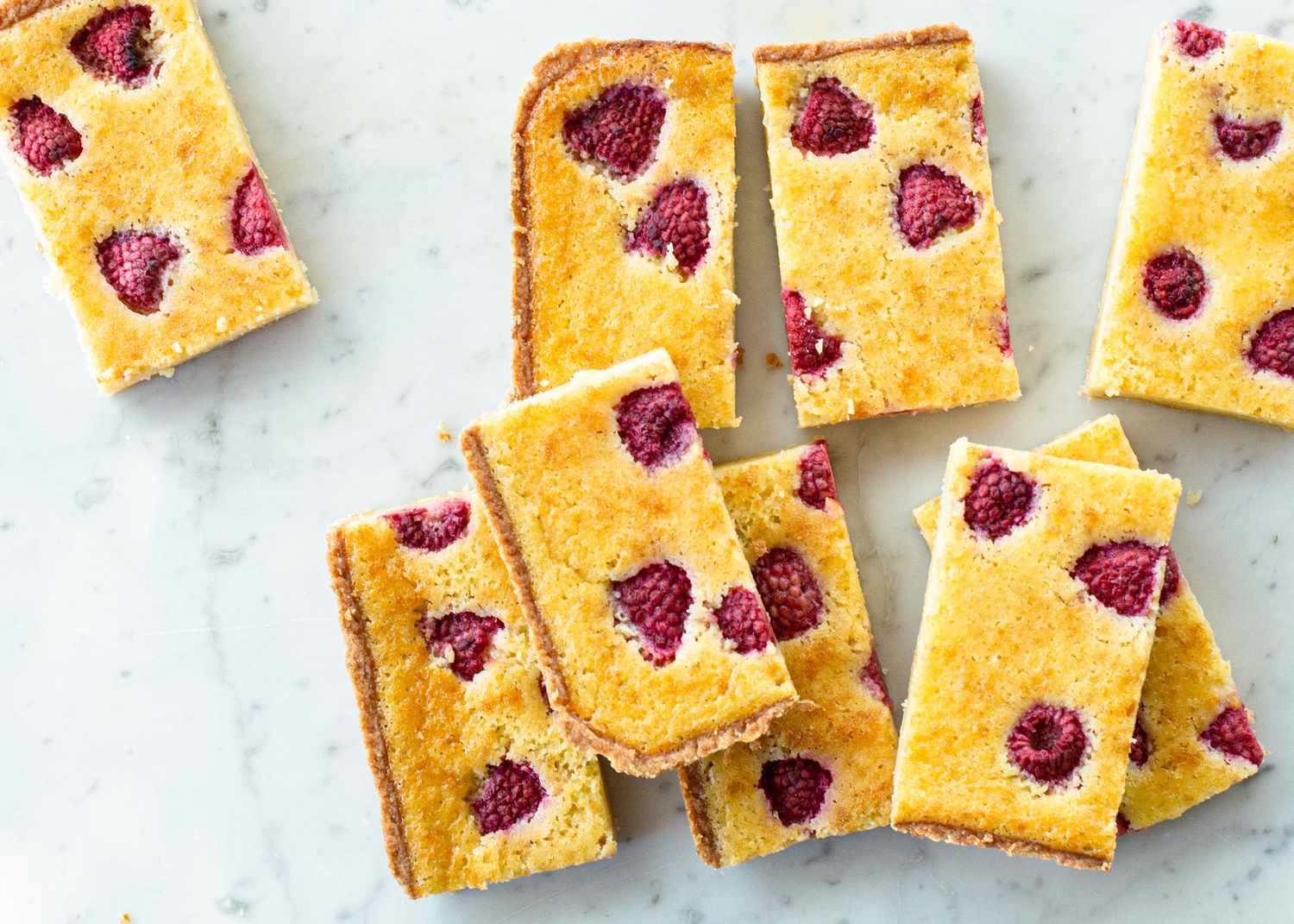 Raspberry chess pie bars cut and stacked.