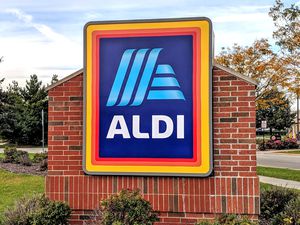 A brick wall featuring the Aldi store logo in a suburban setting