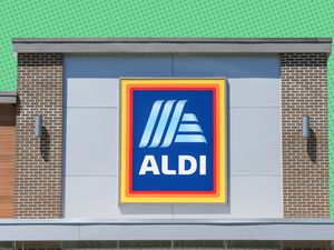 Aldi store-front with a green polka-dotted background 